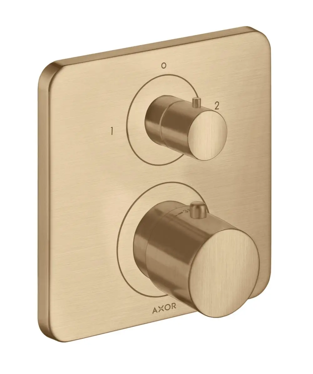 Thermostat mit zwei Drehknöpfen auf quadratischer Plattenschalterflächen in gebürstetem Bronze-Finish, hergestellt von AXOR. Ein Knopf ist für die Temperaturregulierung, der andere für die Umstellung.